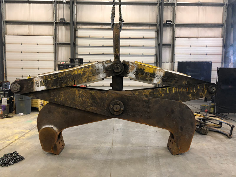 Rusted below the hook auto slab tong crane attachment. 